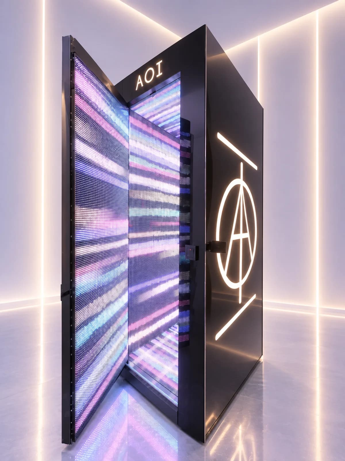An AOI Light Chamber in black, its door open on walls of pink and blue light, the AOI mark glowing on its side