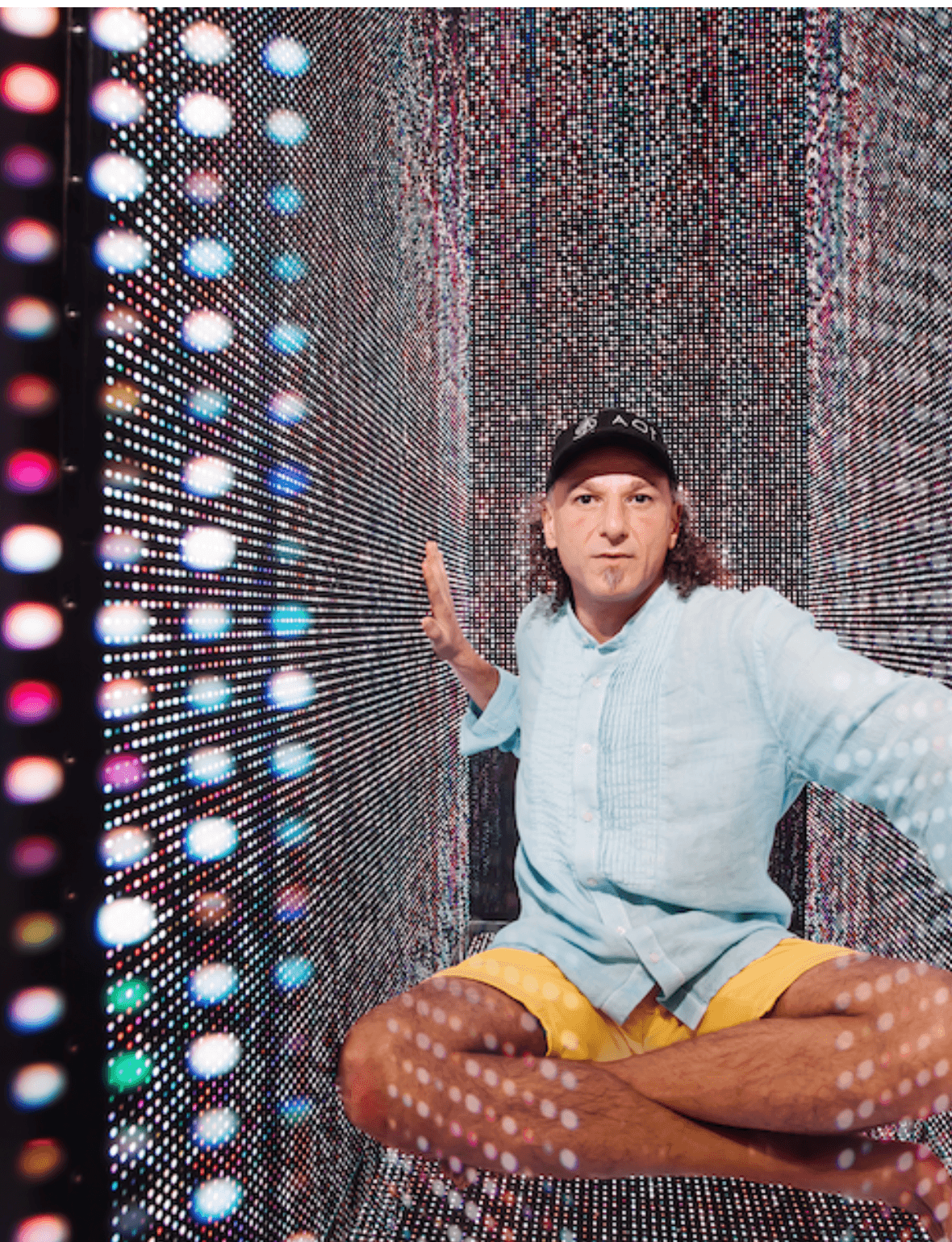 Johny Dar seated inside an illuminated AOI light chamber